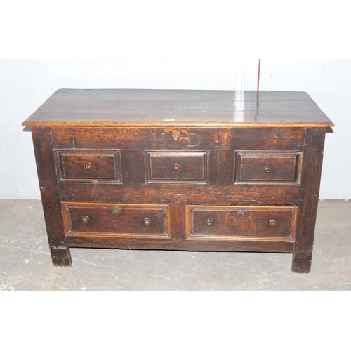 13 - An early 18th century oak mule chest coffer with carved HD and dated 1717, 2 real drawers with brass... 