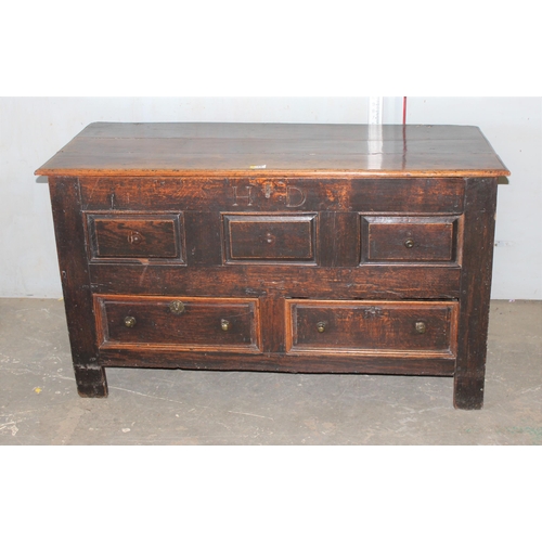 13 - An early 18th century oak mule chest coffer with carved HD and dated 1717, 2 real drawers with brass... 