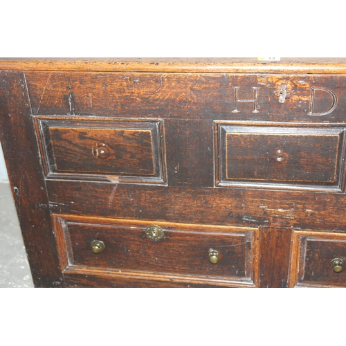 13 - An early 18th century oak mule chest coffer with carved HD and dated 1717, 2 real drawers with brass... 