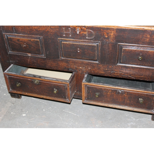 13 - An early 18th century oak mule chest coffer with carved HD and dated 1717, 2 real drawers with brass... 