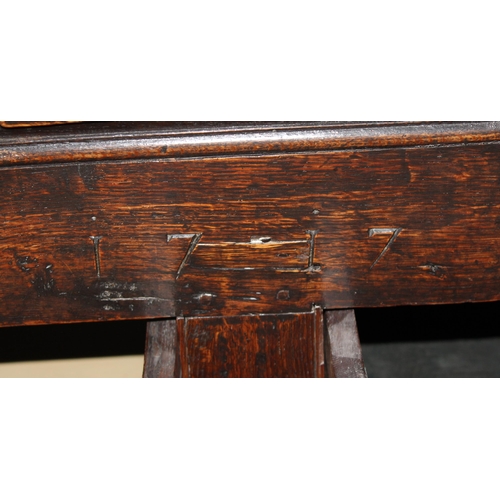 13 - An early 18th century oak mule chest coffer with carved HD and dated 1717, 2 real drawers with brass... 