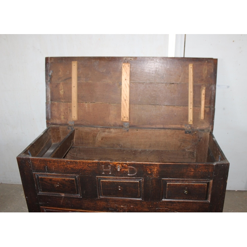 13 - An early 18th century oak mule chest coffer with carved HD and dated 1717, 2 real drawers with brass... 