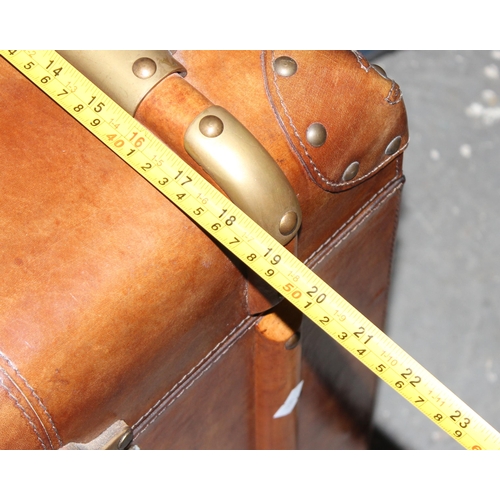 2 - A vintage style leather, brass and wooden storage trunk table, approx 48cm square