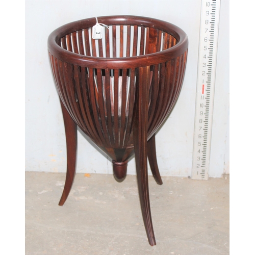 3 - A slatted wooden basket or plant holder on legs