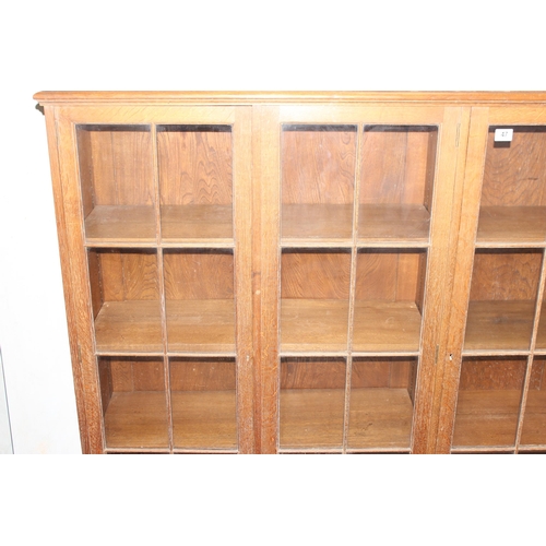 47 - A large early 20th century glazed oak bookcase, in two parts, approx 280cm wide