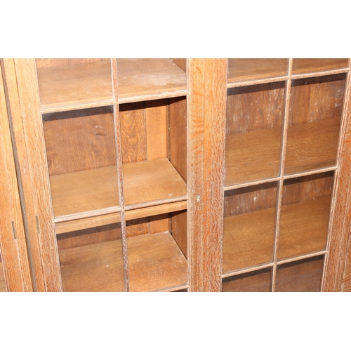 47 - A large early 20th century glazed oak bookcase, in two parts, approx 280cm wide