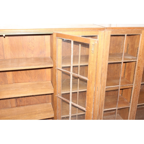 47 - A large early 20th century glazed oak bookcase, in two parts, approx 280cm wide