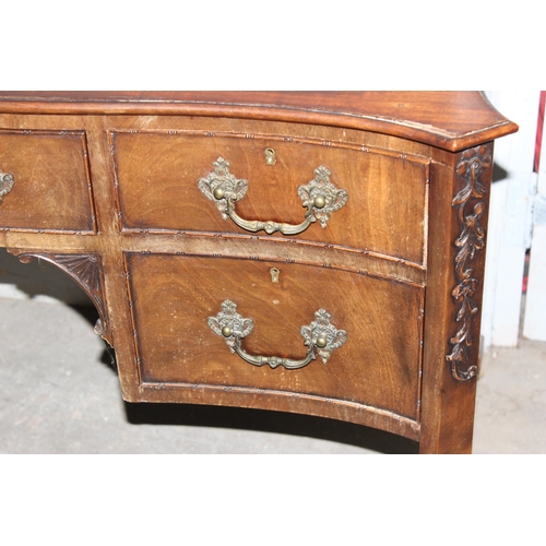 49 - Large antique mahogany serpentine fronted desk with good carved detail, oak lined draws & brass cast... 