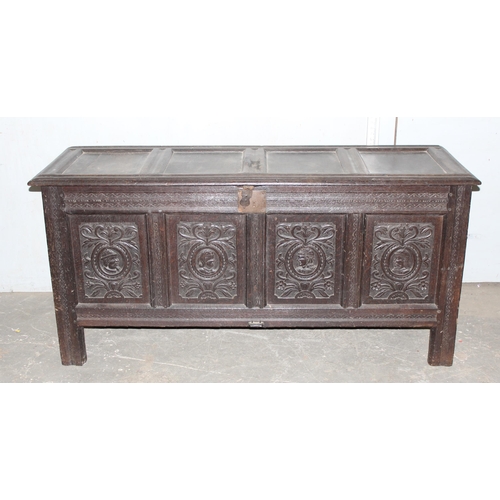 55 - 18th century oak coffer with 4 carved panels depicting faces and period iron work, approx. width 170... 