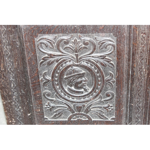 55 - 18th century oak coffer with 4 carved panels depicting faces and period iron work, approx. width 170... 