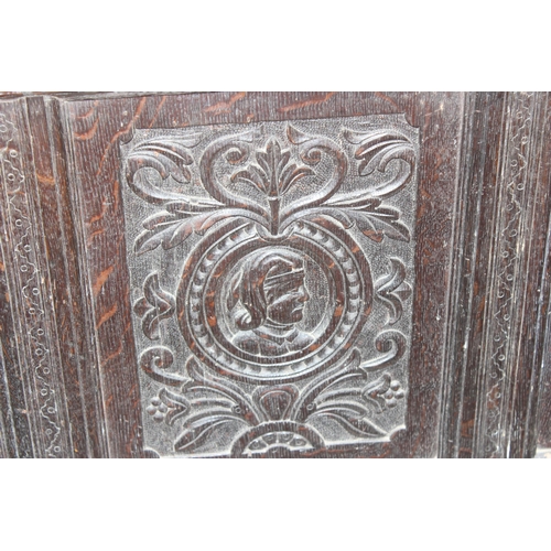 55 - 18th century oak coffer with 4 carved panels depicting faces and period iron work, approx. width 170... 