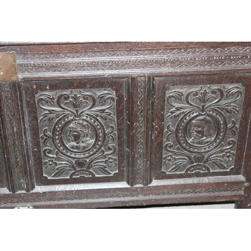 55 - 18th century oak coffer with 4 carved panels depicting faces and period iron work, approx. width 170... 