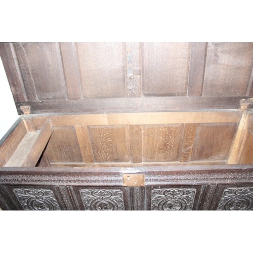 55 - 18th century oak coffer with 4 carved panels depicting faces and period iron work, approx. width 170... 