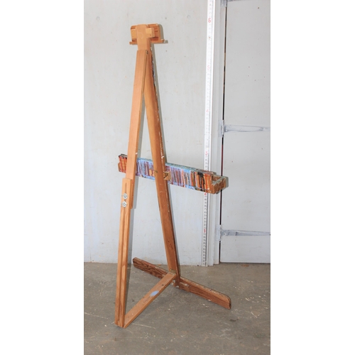 6 - A large vintage wooden floor standing artists' easel, likely early-mid 20th century, various paint m... 