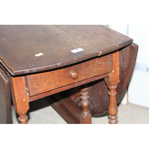 7 - An 18th century oak dropleaf table with drawer, approx 127cm wide (155cm when extended)