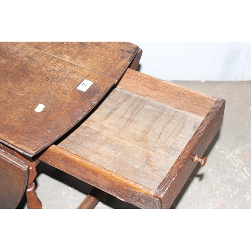 7 - An 18th century oak dropleaf table with drawer, approx 127cm wide (155cm when extended)