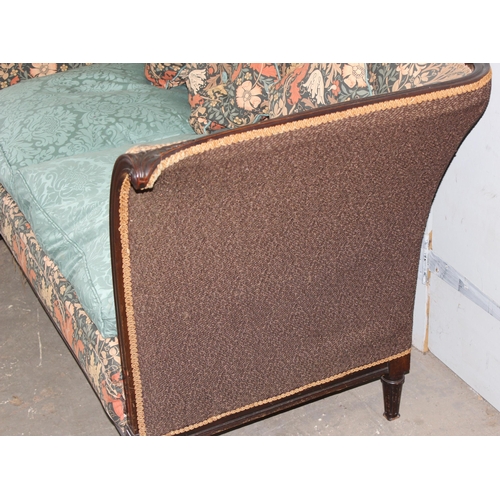 72 - An antique wooden framed couch or love seat with carved details and William Morris style upholstery ... 