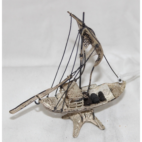 1005 - A small silver filigree model of a Chinese junk boat, unmarked but XRF tested over 90% pure, approx ... 