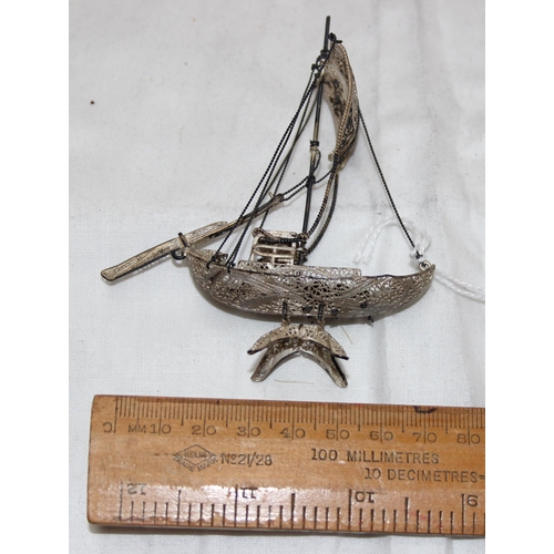 1005 - A small silver filigree model of a Chinese junk boat, unmarked but XRF tested over 90% pure, approx ... 