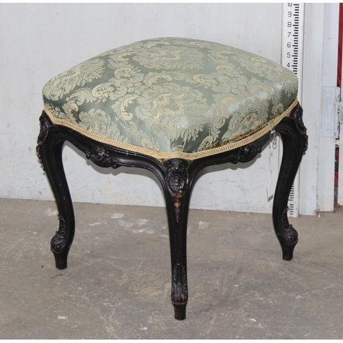 66 - A 19th century Continental ebonised and profusely carved stool with stuffed green fabric top in the ... 