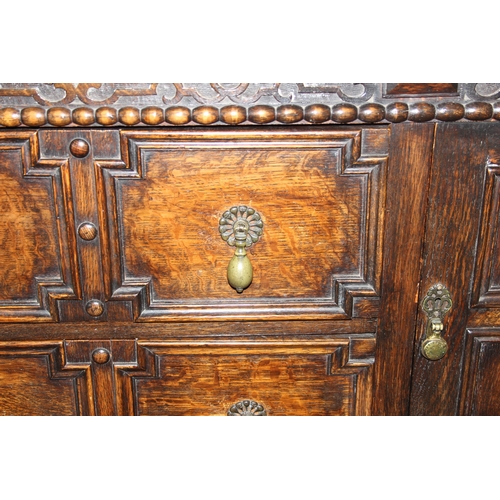 71 - An early 20th century Jacobean style oak sideboard with carved details