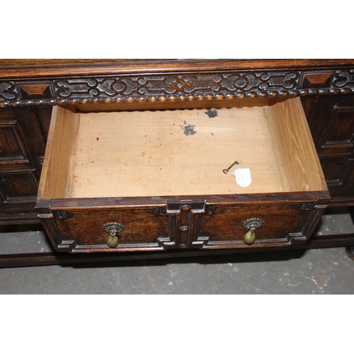 71 - An early 20th century Jacobean style oak sideboard with carved details