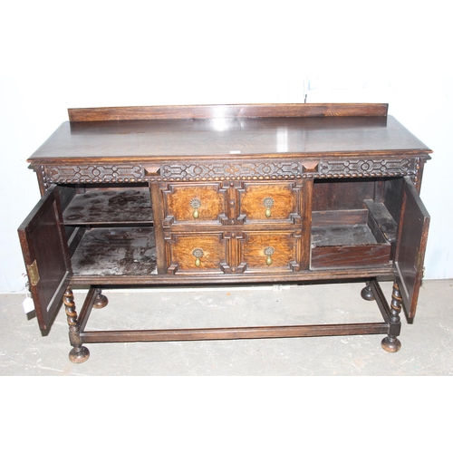 71 - An early 20th century Jacobean style oak sideboard with carved details