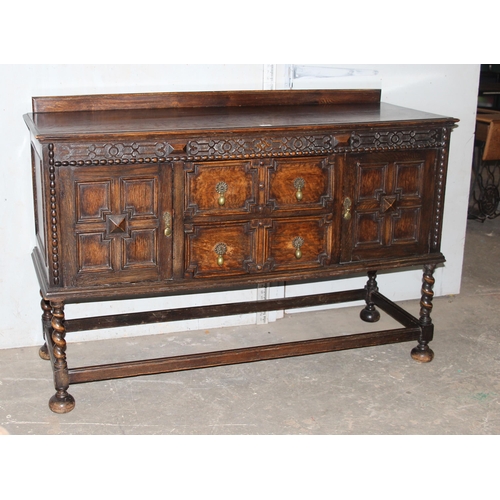 71 - An early 20th century Jacobean style oak sideboard with carved details