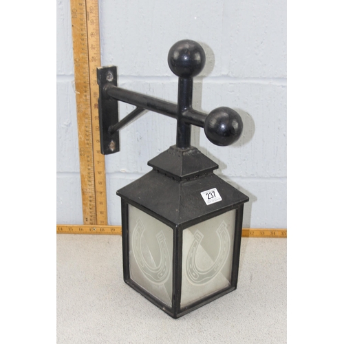 237 - A set of 4 hanging outdoor lamps with horseshoe glass panels