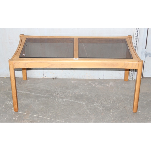 84 - Blonde Ercol coffee table with smoked glass panels