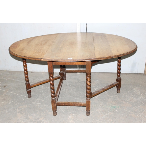 93 - Antique oak drop leaf dining table with barley twist supports