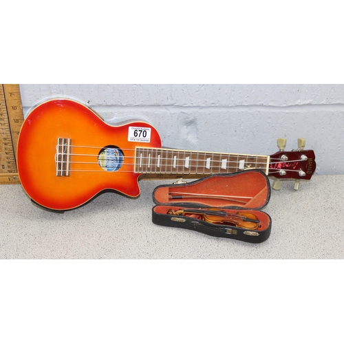 670 - Wooden bodied four string Ukulele and a scale model miniature violin and bow in fitted case. (2 item... 