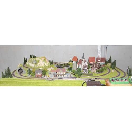 1539 - A large professionally commissioned Fleischmann N gauge track and landscape layout, approx 127cm x 9... 