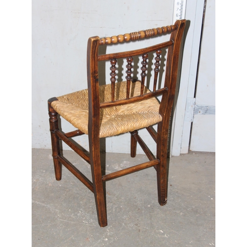 112 - A set of 6 Arts & Crafts period rush seated chairs with bobbin turned back and bamboo effect stretch... 