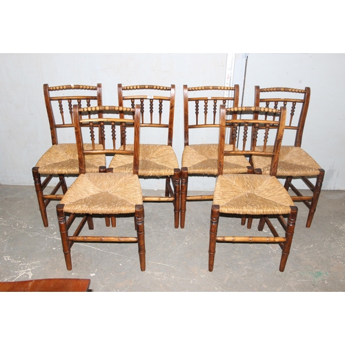 112 - A set of 6 Arts & Crafts period rush seated chairs with bobbin turned back and bamboo effect stretch... 