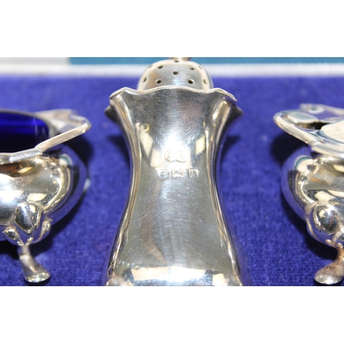 1026 - A boxed silver cruet set, Birmingham 1925/6 by William Suckling and 2 associated silver spoons, appr... 