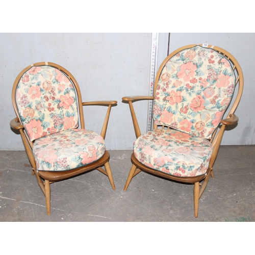 130 - Pair of blonde Ercol low easy lounge chairs with floral cushions, blue & gold labels