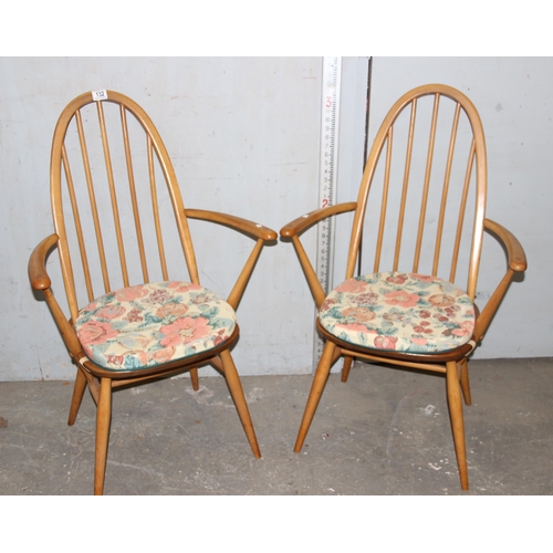 132 - Pair of blonde Ercol Windsor high hoop back carver dining chairs with cushions