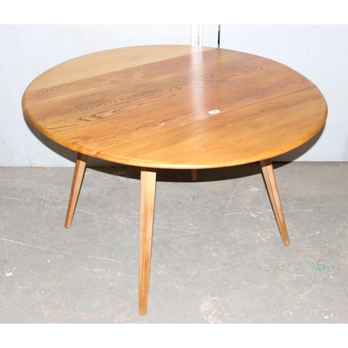 138 - Blonde Ercol round drop leaf table, diameter approx 112cm