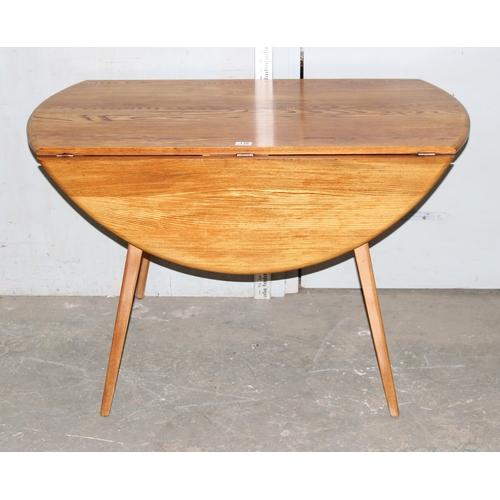 138 - Blonde Ercol round drop leaf table, diameter approx 112cm