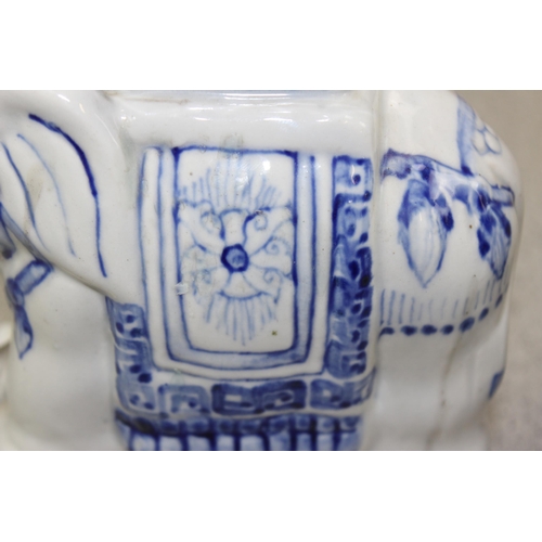 1780 - A pair of blue and white glazed pottery elephant formed candlesticks