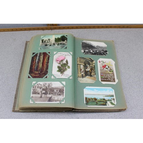 586 - Early 20th century postcard album and contents