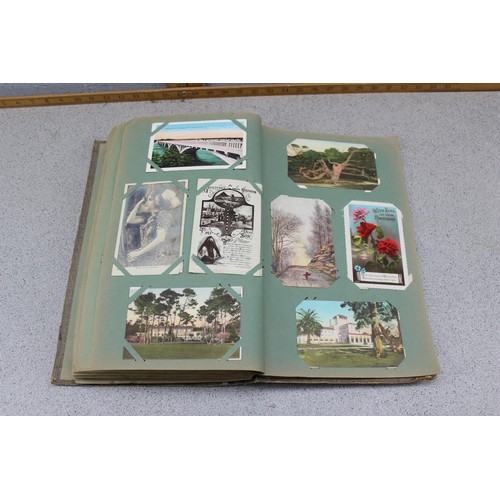 586 - Early 20th century postcard album and contents