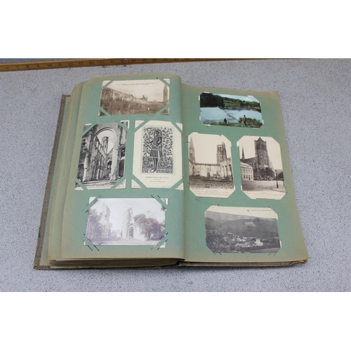 586 - Early 20th century postcard album and contents