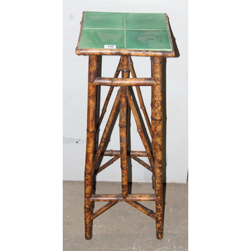 146 - In the manner of Liberty & Co an antique tile topped bamboo jardinière stand