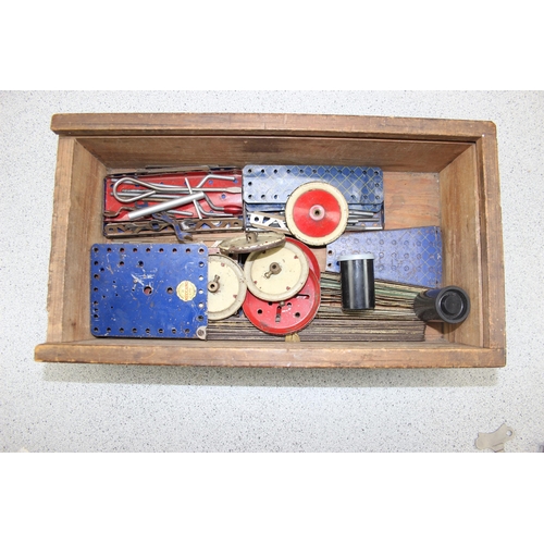 1553 - Wooden box full of early Meccano to include clockwork motor