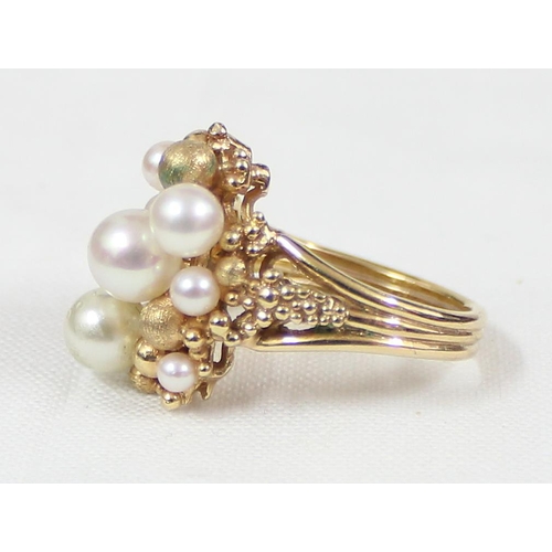 1115 - An unusual retro cocktail ring set with faux pearls and gold beads, import marks for London 1975, ap... 