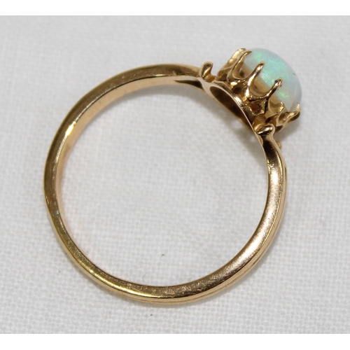 1124 - 18ct gold and opal ring in claw setting, indistinctly marked but XRF tested at 18ct, approx size S, ... 