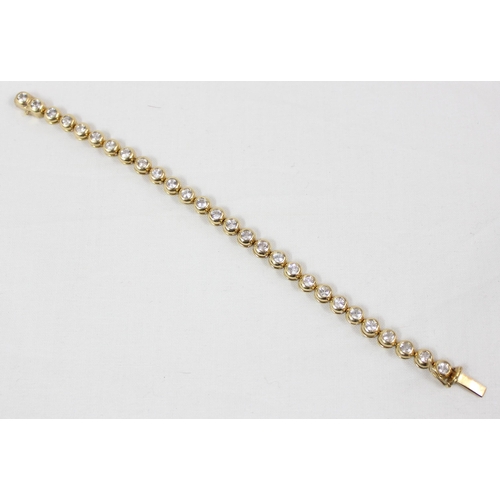 1133 - A 14ct gold mounted tennis bracelet set with 28 cut white stones (believed to be diamonds) in bubble... 