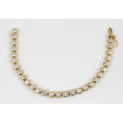 1133 - A 14ct gold mounted tennis bracelet set with 28 cut white stones (believed to be diamonds) in bubble... 